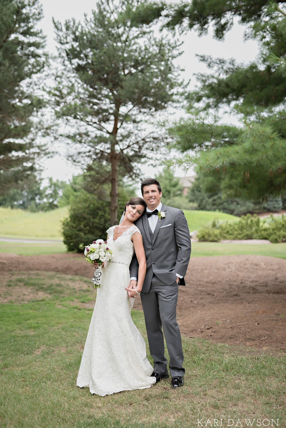 Lace wedding dress with open back l Rustic bouquet l Grey tuxedo l Bow tie l Rustic elegant black tie country club wedding