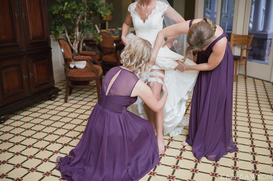 This lovely bride is getting ready for her rustic elegant black tie country club wedding l garter l purple bridesmaid dress