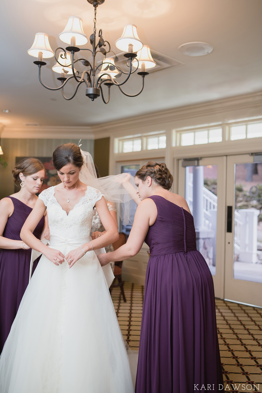 This lovely bride is getting ready for her rustic elegant black tie country club wedding l garter l purple bridesmaid dress
