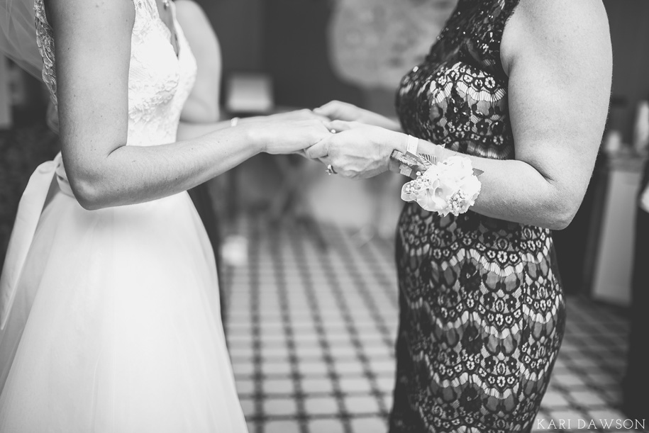 A beautiful moment as the bride and her mom prepare this rustic elegant black tie country club wedding