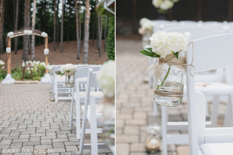 A rustic outdoor ceremony in the woods l rustic elegance l black tie country club wedding l hydrangeas in mason jars wrapped in twine line the chairs in the aisle l rustic branch arbor