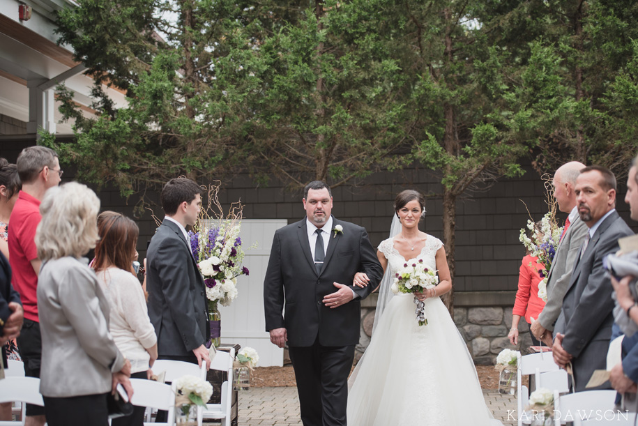 Father of the bride walks his daughter down the aisle for this rustic elegant outdoor wedding ceremony in the woods.