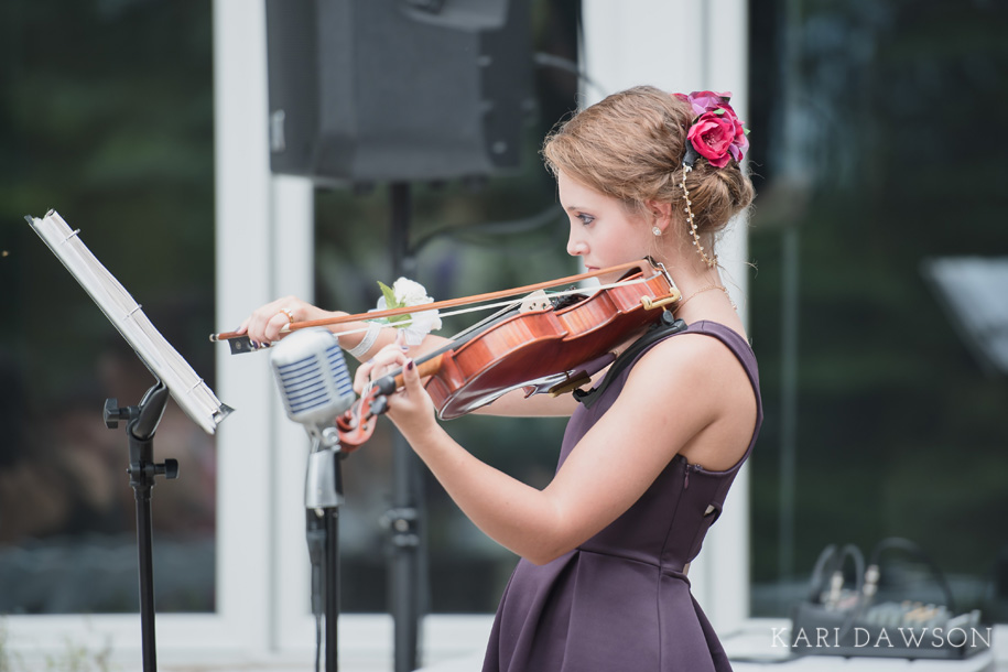 Having a violinist is an elegant touch for a rustic outdoor wedding ceremony in the woods.