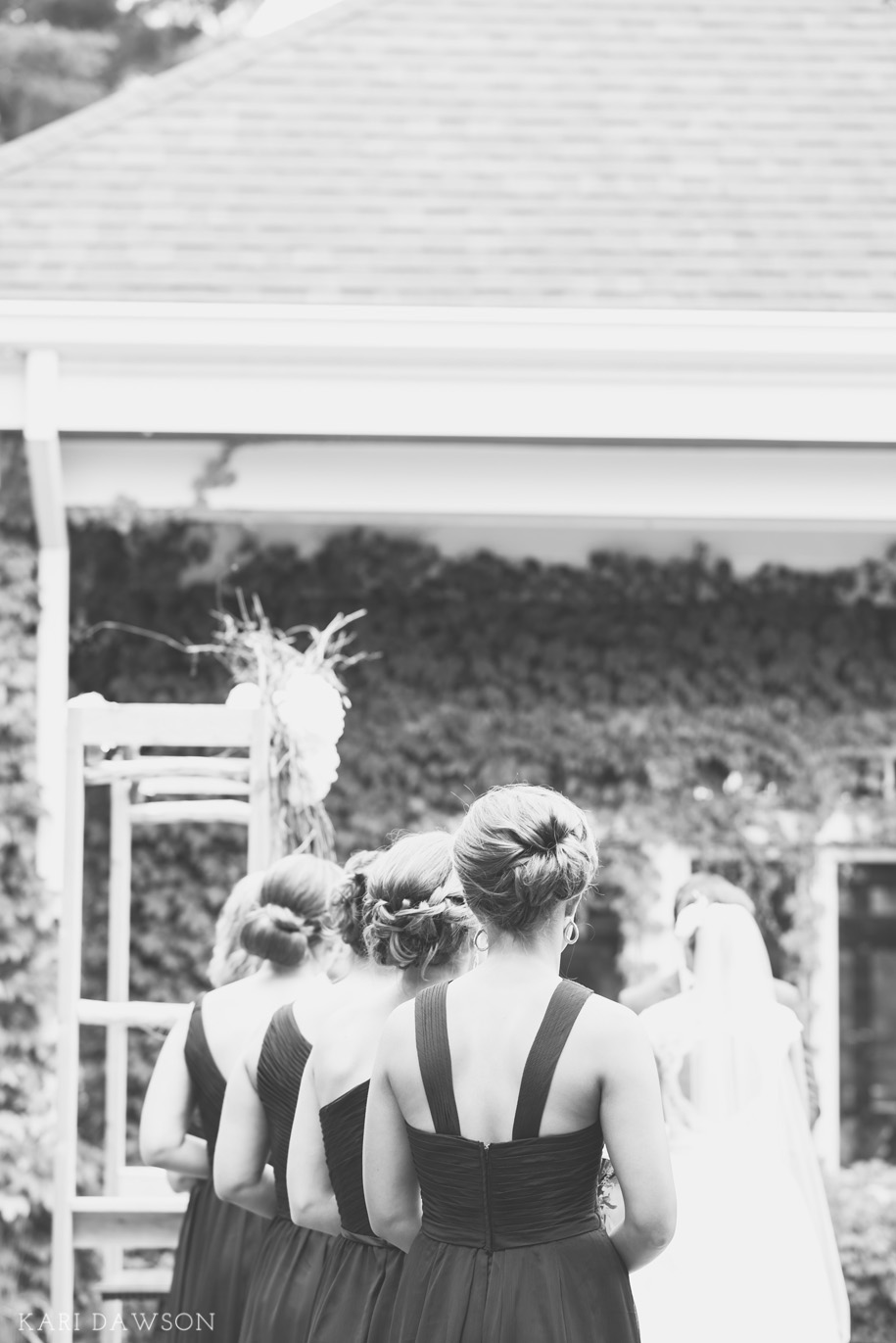 Bridesmaids in purple for this rustic elegant outdoor wedding ceremony in the woods l Rustic branch arbor