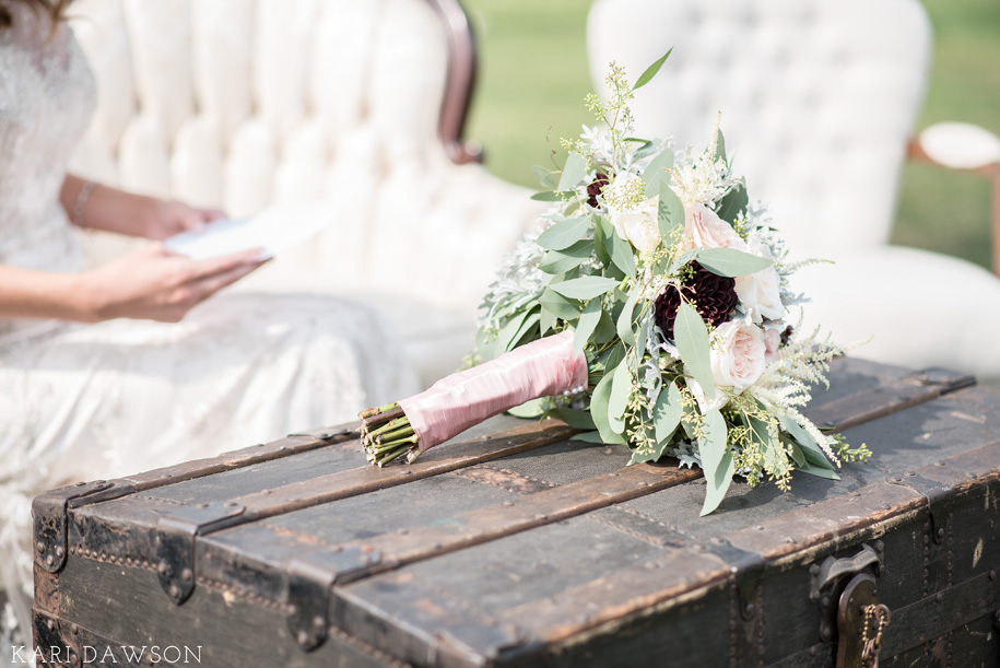 rustic bouquet in pinks, greens, and wine and vintage furniture