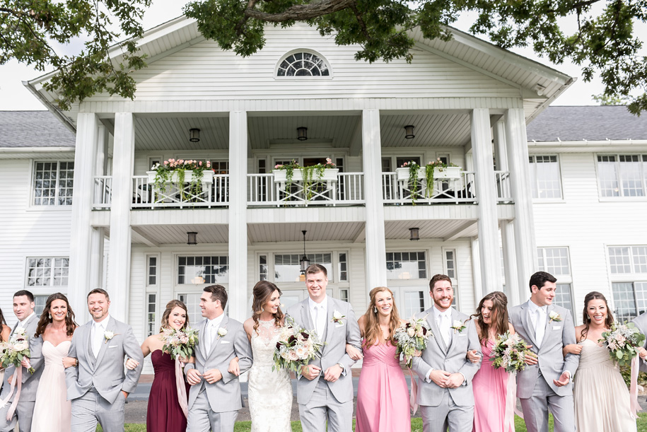 Rustic summer wedding with bridesmaids in pinks and wines and groomsman in gray with white ties l Romantic Waldenwoods Wedding