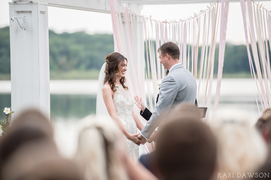 The ribbons swaying in the wind at the altar for this outdoor wedding ceremony is gorgeous. Made extra special by this giggling bride.