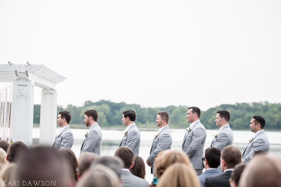 Love these gray suits and white ties on the groomsman for this elegant outdoor wedding ceremony