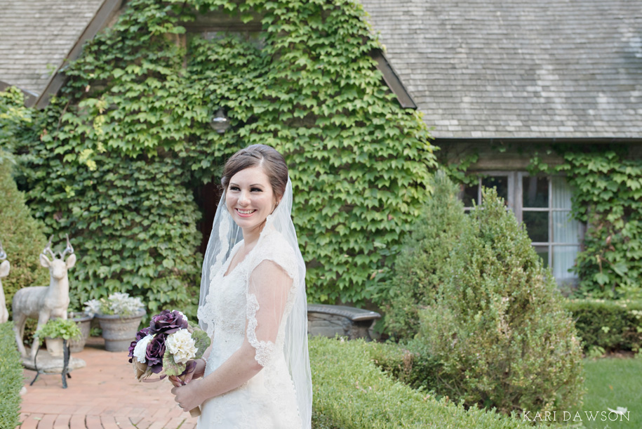 What a beaming bride in her lace v-neck wedding gown with cap sleeve and high back lace l lace trimmed veil l Outdoor Inner Circle Estate Wedding by Kari Dawson