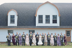 Groomsman in grey tuxedos and black bow ties . Bridesmaids in pinks, purples and plums. Rustic and romantic barn wedding ceremony at On Eagles Wings in Midland Michigan.