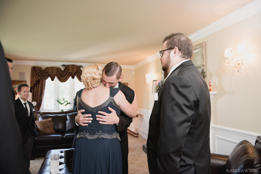 A tender moment between the groom and mother of the groom. A fall wedding in Michigan by Kari Dawson