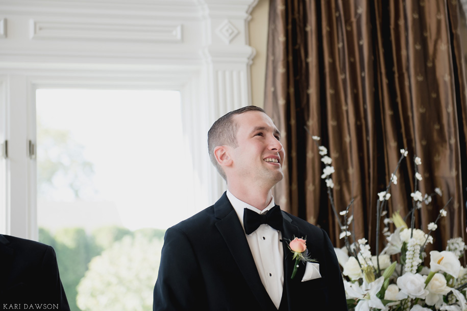 A groom's first look as his bride comes down the aisle. A fall wedding in Michigan by Kari Dawson