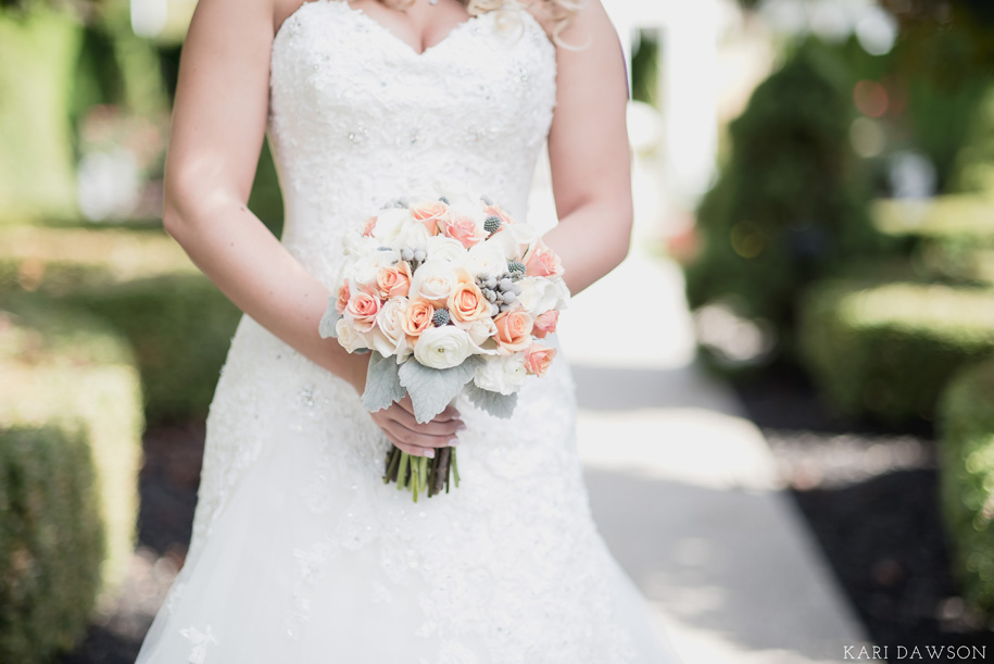 Romantic and classic pastel bride wedding day bouquet in neutral tones of cream and grey with pops of pink and peach for this fall Michigan wedding by Kari Dawson.