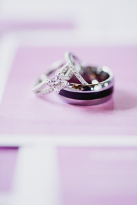 These lilac and white water color wedding invitations served as a lovely backdrop for the couple's wedding ring set.