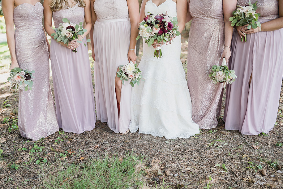 Blush flowy floor length bridesmaid dresses in a variety of styles. Planterra wedding day bouquet in shades of pink and cranberry with lush greens and wrapped in silk ribbon.