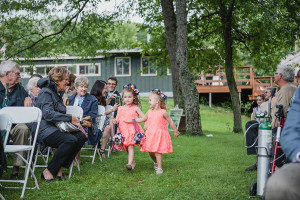 Flower Girls. Outdoor wedding ceremony in the rain. Navy and coral Skyline Camp wedding in the woods in Almont, Michigan by Kari Dawson Photography, top rated Metro Detroit Wedding Photographer.