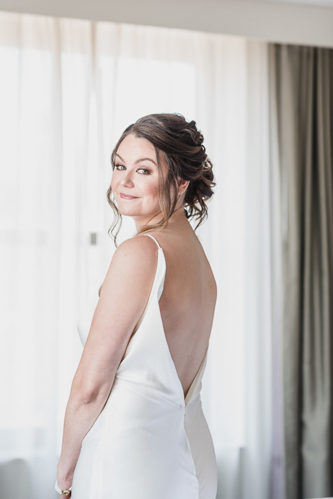 Simple backless wedding dress. Coral and Gray College for Creative Studies Summer Wedding in Detroit, Michigan by Kari Dawson Photography.
