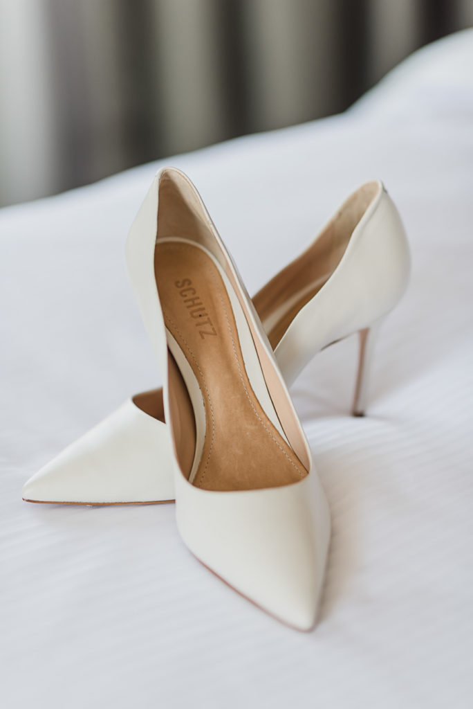 These Schutz white leather pointed toe heels are such a unique find for a bride on her wedding day. Coral and Gray College for Creative Studies Summer Wedding in Detroit, Michigan by Kari Dawson Photography.