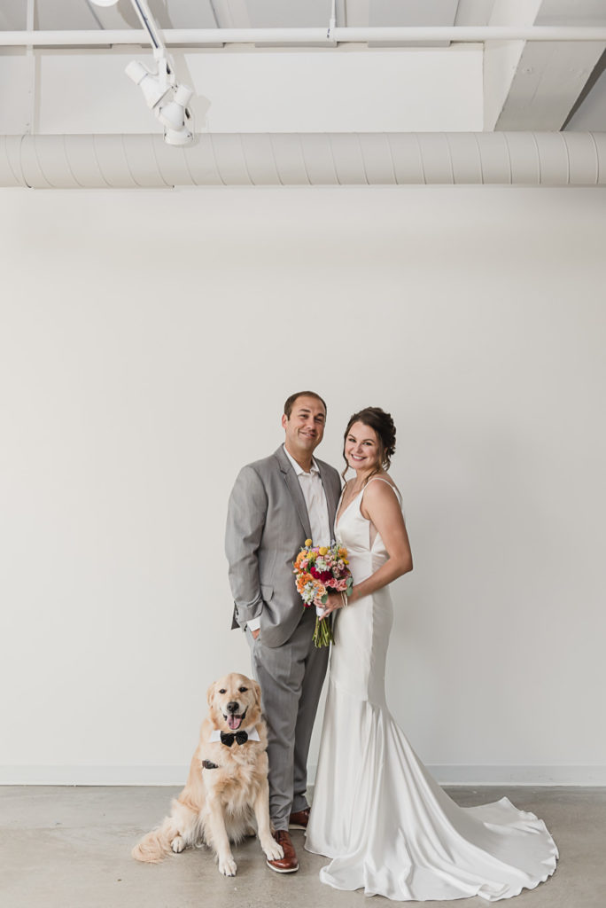 Bride and groom portraits with their dog on their wedding day. I absolutely love it when couples have their dogs or puppies as part of their wedding day! Coral and Gray College for Creative Studies Summer Wedding in Detroit, Michigan by Kari Dawson Photography.