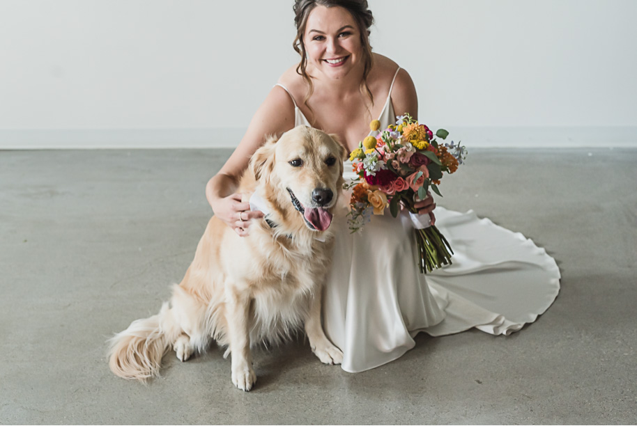 A bride and her puppy on her wedding day! Coral and Gray College for Creative Studies Summer Wedding in Detroit, Michigan by Kari Dawson Photography.