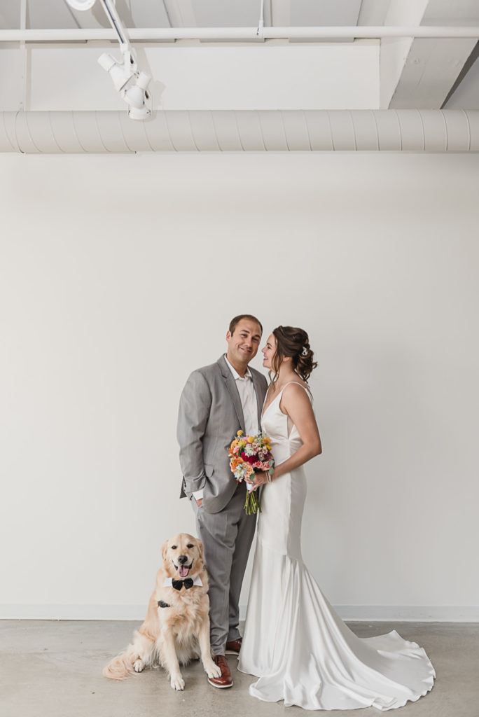 A couple and their puppy on her wedding day! Coral and Gray College for Creative Studies Summer Wedding in Detroit, Michigan by Kari Dawson Photography.