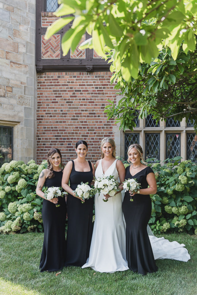 Mix and match black floor length bridesmaid dresses. This Black and white summer Meadow Brook Hall wedding in Rochester, Michigan is elegant, modern, romantic, yet unique, and classic. Provided by Kari Dawson, top-rated Rochester wedding photographer, and her team. 