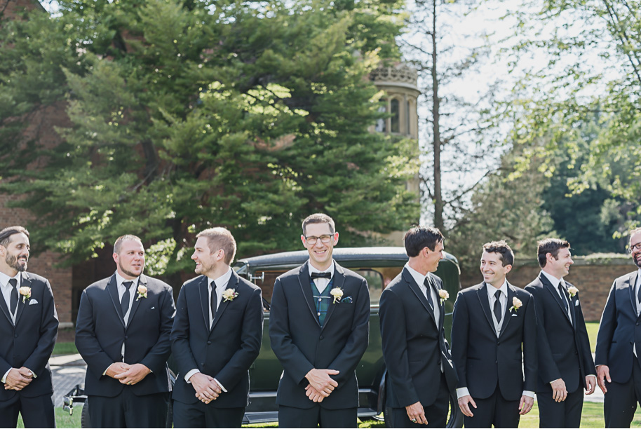The groom's scottish tartan vest really pops in front of his classic model T at Meadow Brook Hall. Colorful Meadow Brook Mansion wedding in Rochester, Michigan provided by Kari Dawson, top-rated Rochester, Michigan wedding photographer, and her team. 