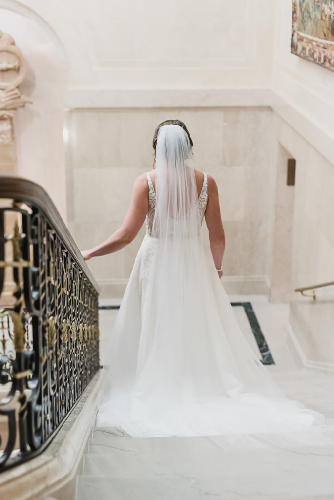 Those final moments before you finally get to have your first look. Sage and navy summer wedding at the Detroit Athletic Club in Detroit, Michigan provided by Kari Dawson, top-rated Detroit wedding photographer, and her team.