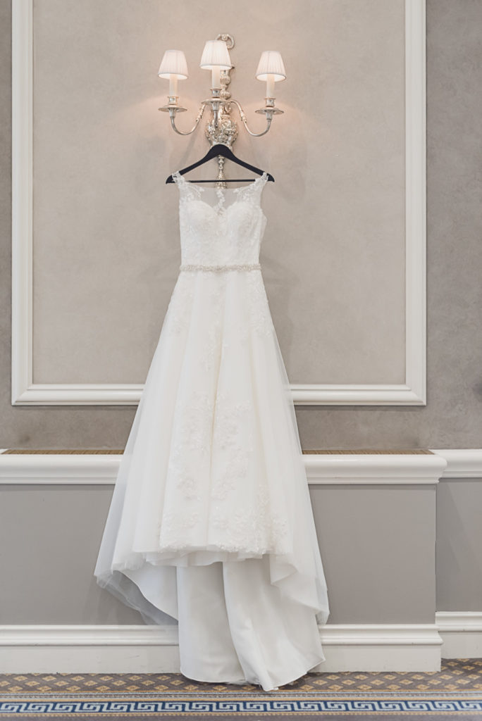 Lace appliqué a line wedding gown with a sweetheart and illusion neckline and open back. Sage and navy summer wedding at the Detroit Athletic Club in Detroit, Michigan provided by Kari Dawson, top-rated Detroit wedding photographer, and her team.