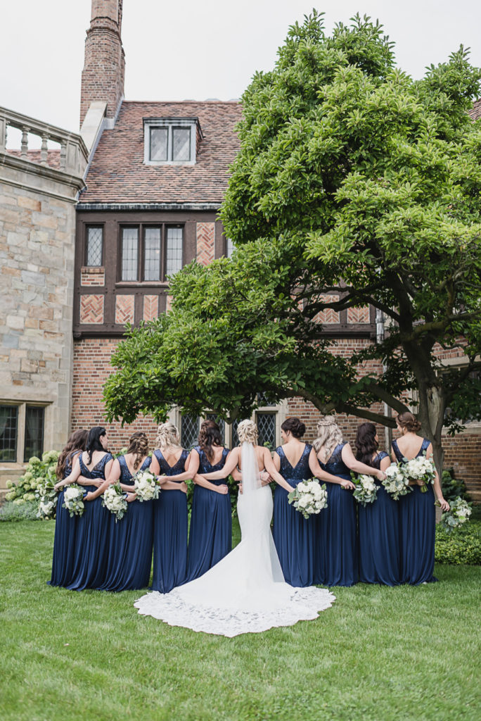 Navy sequin floor length bridesmaid dresses. Gray and navy Meadow Brook wedding at Meadow Brook Hall and Gardens in Rochester, Michigan provided by Kari Dawson, top-rated Rochester engagement and wedding photographer, and her team. 