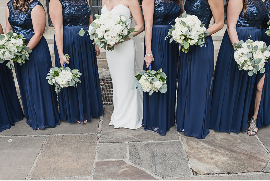 Navy sequin floor length bridesmaid dresses. Lucious unstructured bouquets. Gray and navy Meadow Brook wedding at Meadow Brook Hall and Gardens in Rochester, Michigan provided by Kari Dawson, top-rated Rochester engagement and wedding photographer, and her team. 