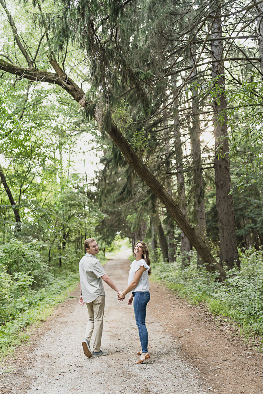Sunset Metro Detroit engagement photos in the woods at Stony Creek in Washington, Michigan provided by Kari Dawson, top-rated Detroit wedding photographer, and her team. 