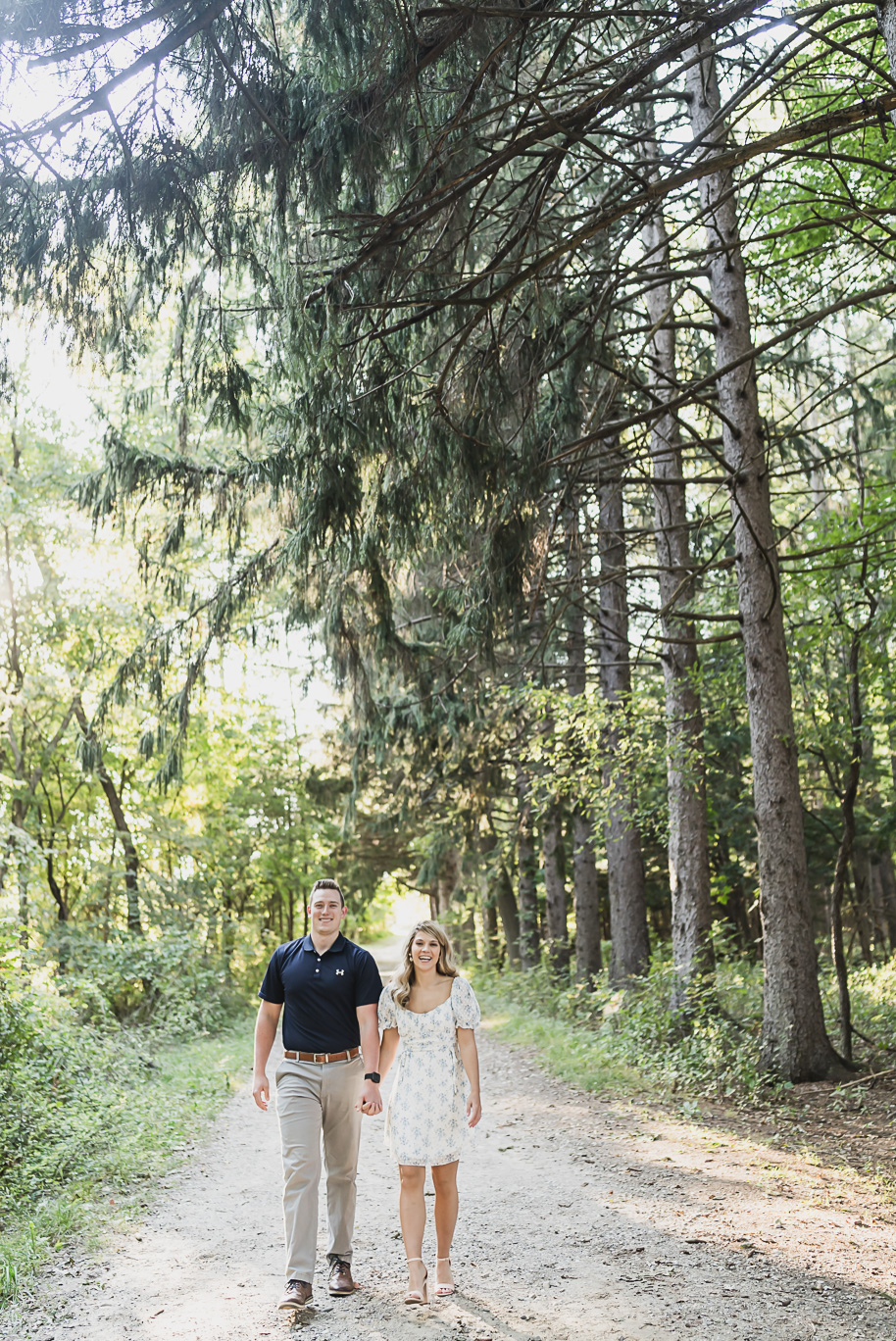 Fall romantic sunset engagement pictures at Stony Creek Metro Park in Washington, Michigan provided by Kari Dawson, top-rated Metro Detroit wedding photographer, and her team.