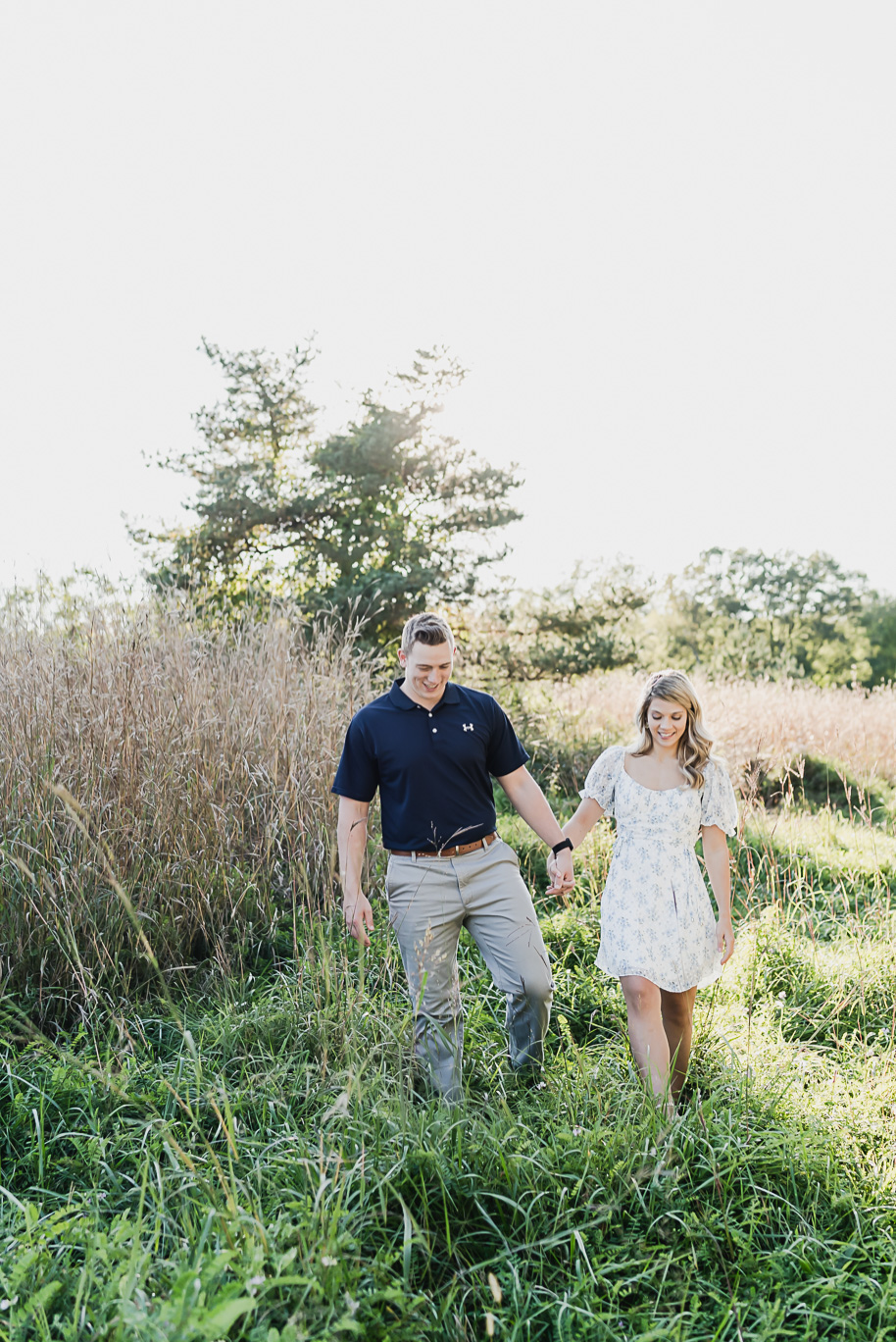 Fall romantic sunset engagement pictures at Stony Creek Metro Park in Washington, Michigan provided by Kari Dawson, top-rated Metro Detroit wedding photographer, and her team.