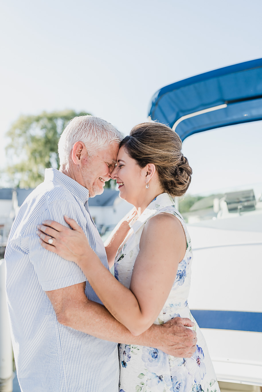 New Baltimore engagement session on a boat at the marina under the michigan summer setting sun provided by Kari Dawson, top-rated Metro Detroit wedding photographer.