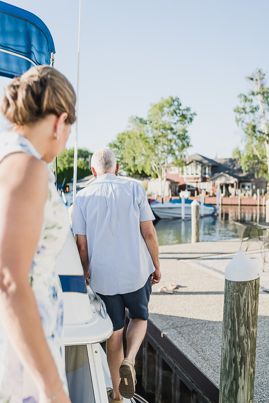New Baltimore engagement session on a boat at the marina under the michigan summer setting sun provided by Kari Dawson, top-rated Metro Detroit wedding photographer.