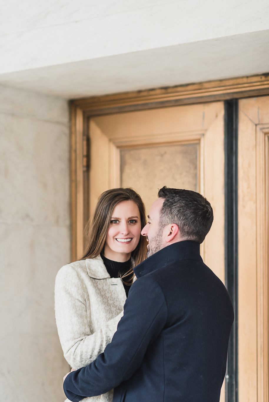 Downtown Detroit engagement photos in the winter at the Shinola Hotel and Detroit Institute of Arts with their adorable bernadoodle puppy by top-rated Detroit wedding photographer Kari Dawson.