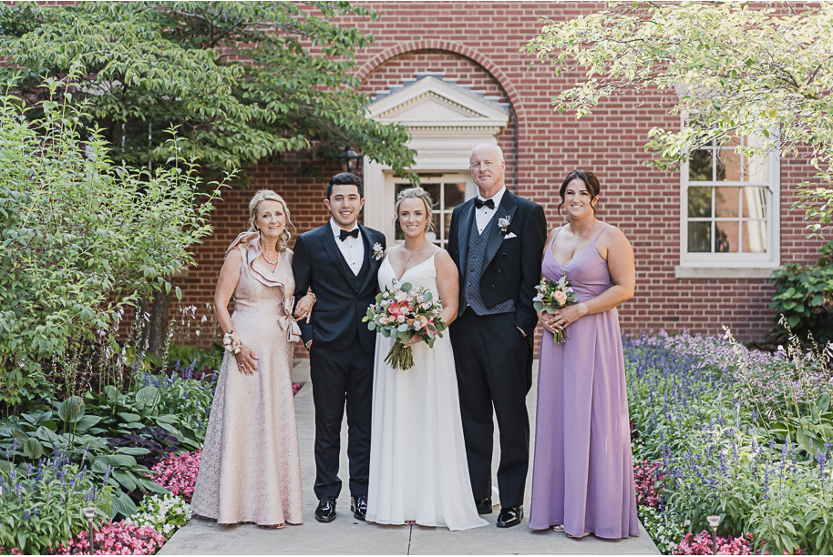 A sunny summer pastel color palette Lovett Hall wedding in Dearborn, Michigan at Greenfield Village provided by Kari Dawson.