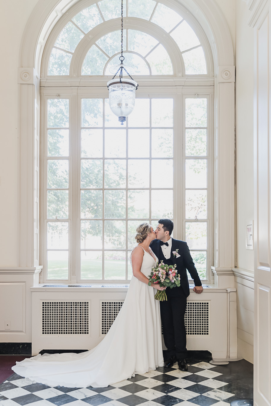 A sunny summer pastel color palette Lovett Hall wedding in Dearborn, Michigan at Greenfield Village provided by Kari Dawson.