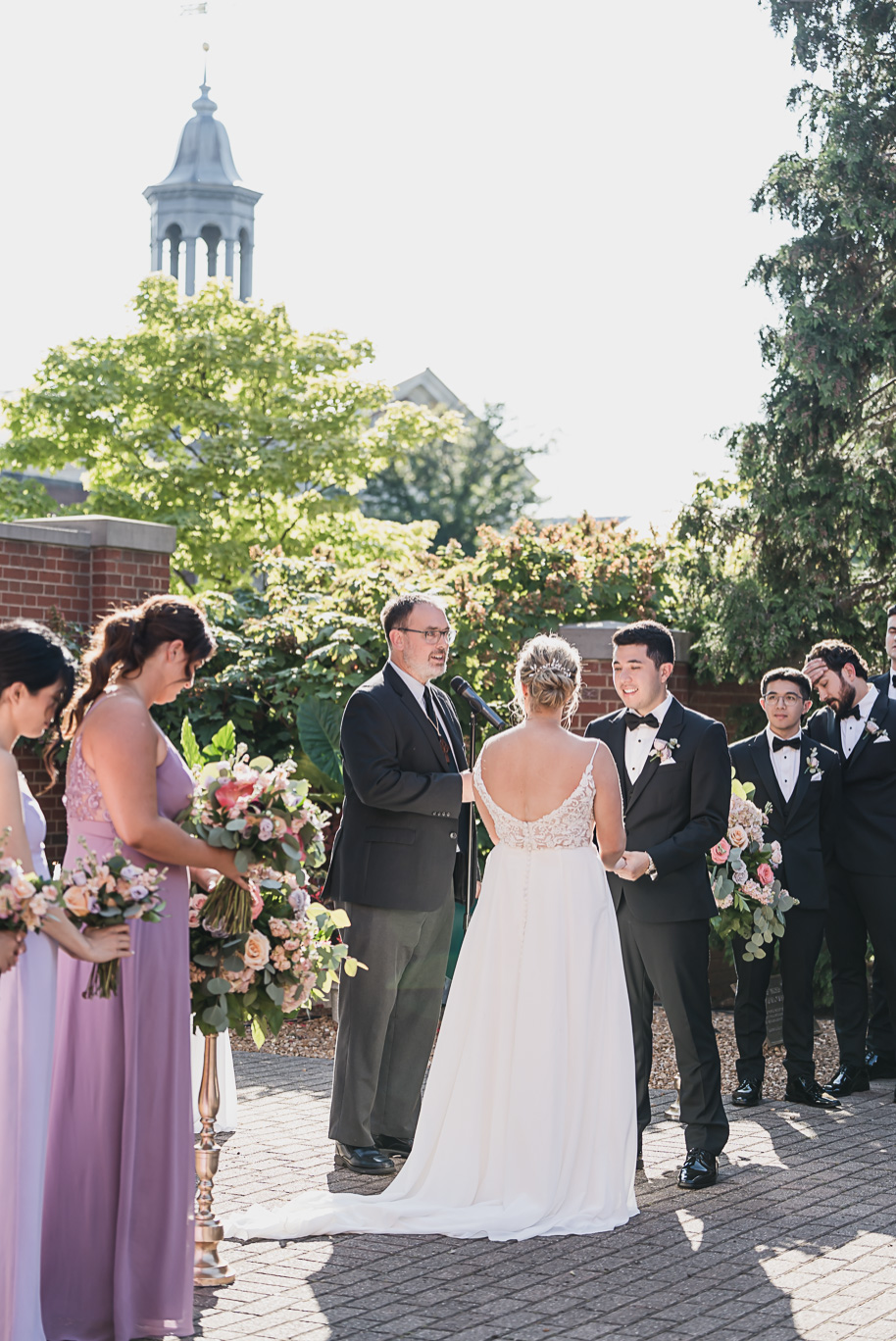 A sunny summer pastel color palette Lovett Hall wedding in Dearborn, Michigan at Greenfield Village provided by Kari Dawson.