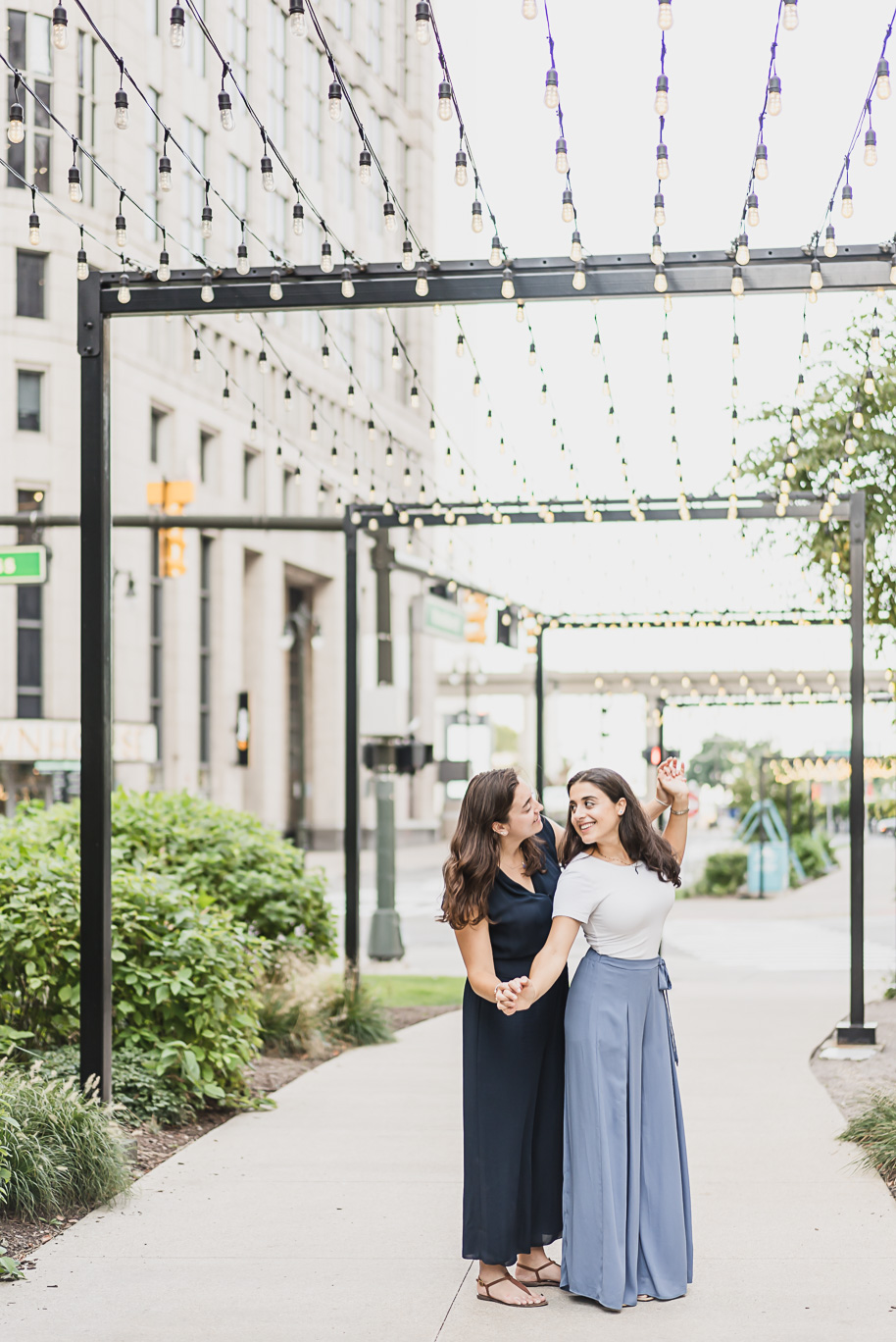 A same sex downtown Detroit engagement session in the summer provided by top-rated Detroit wedding photographer Kari Dawson.