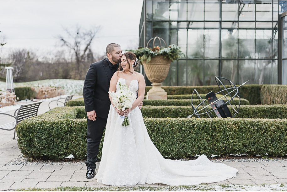 A classic black and white black tie winter Planterra wedding in West Bloomfield, Michigan provided by top-rated Detroit wedding photographer, Kari Dawson and her team.