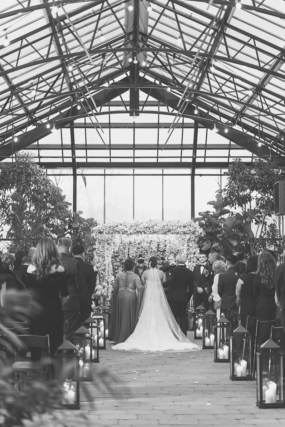 A classic black and white black tie winter Planterra wedding in West Bloomfield, Michigan provided by top-rated Detroit wedding photographer, Kari Dawson and her team.