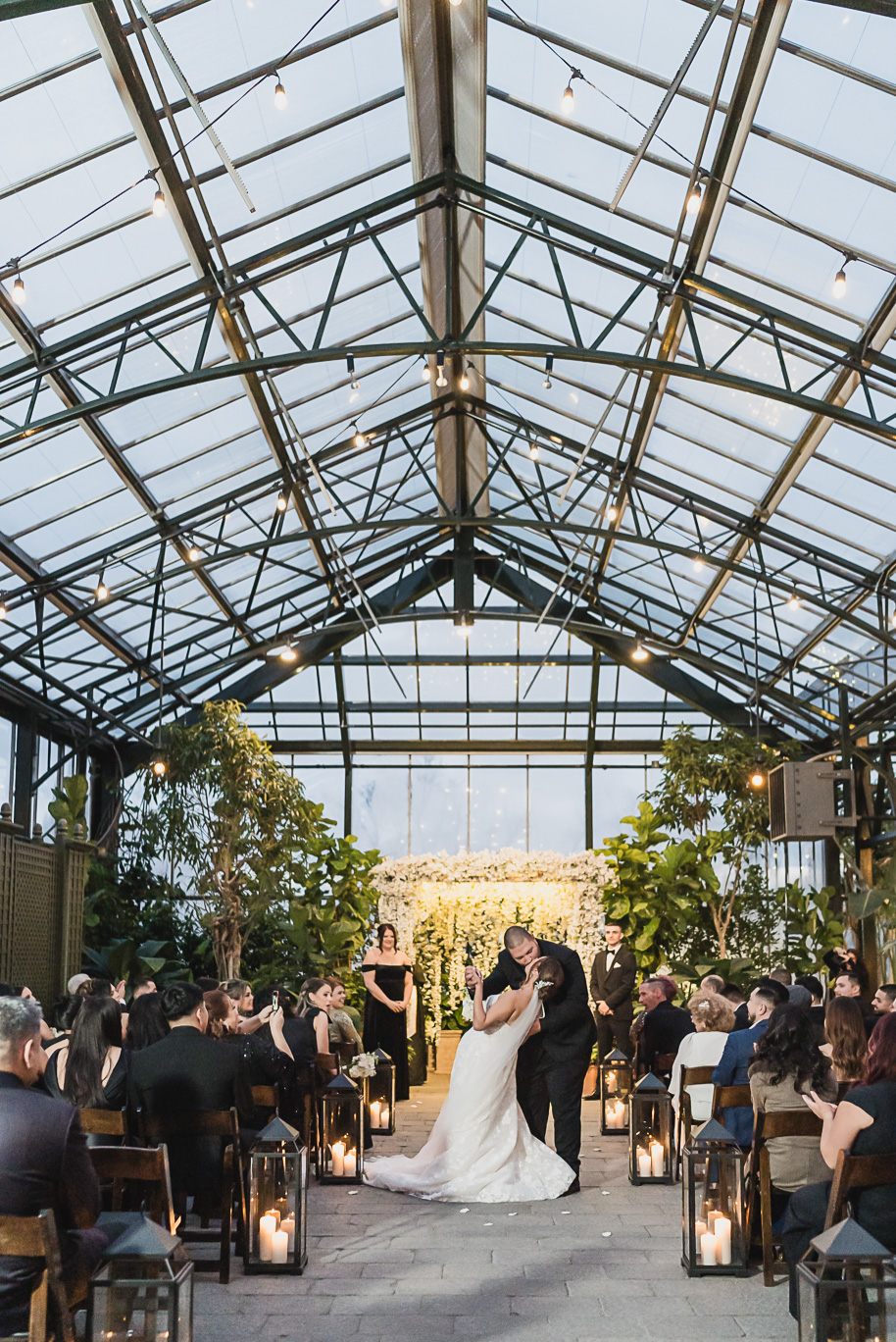 A classic black and white black tie winter Planterra wedding in West Bloomfield, Michigan provided by top-rated Detroit wedding photographer, Kari Dawson and her team.