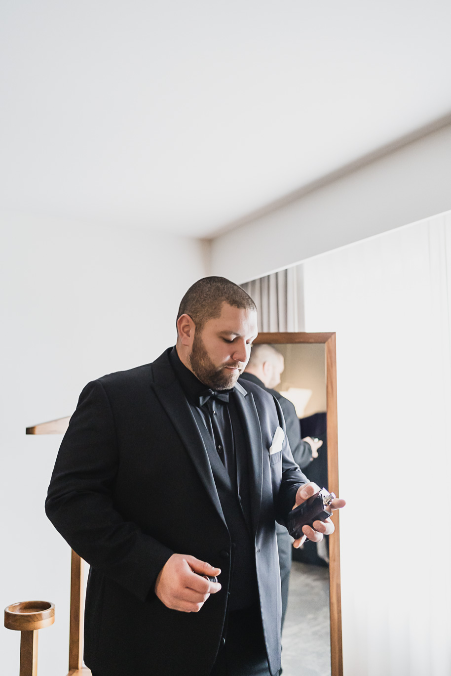 A classic black and white black tie winter Planterra wedding in West Bloomfield, Michigan provided by top-rated Detroit wedding photographer, Kari Dawson and her team.