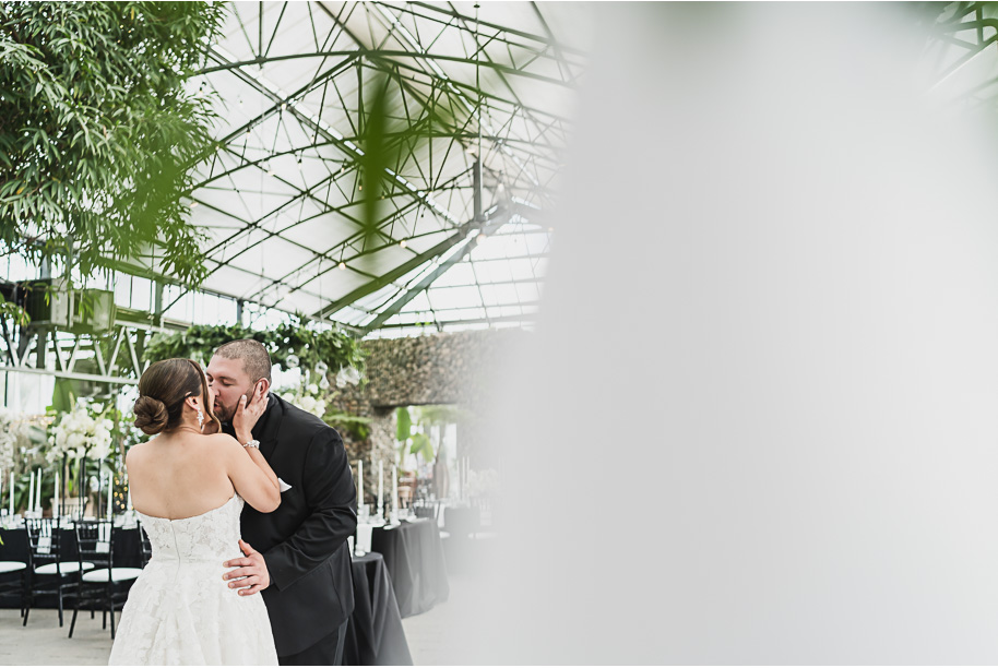 A classic black and white black tie winter Planterra wedding in West Bloomfield, Michigan provided by top-rated Detroit wedding photographer, Kari Dawson and her team.