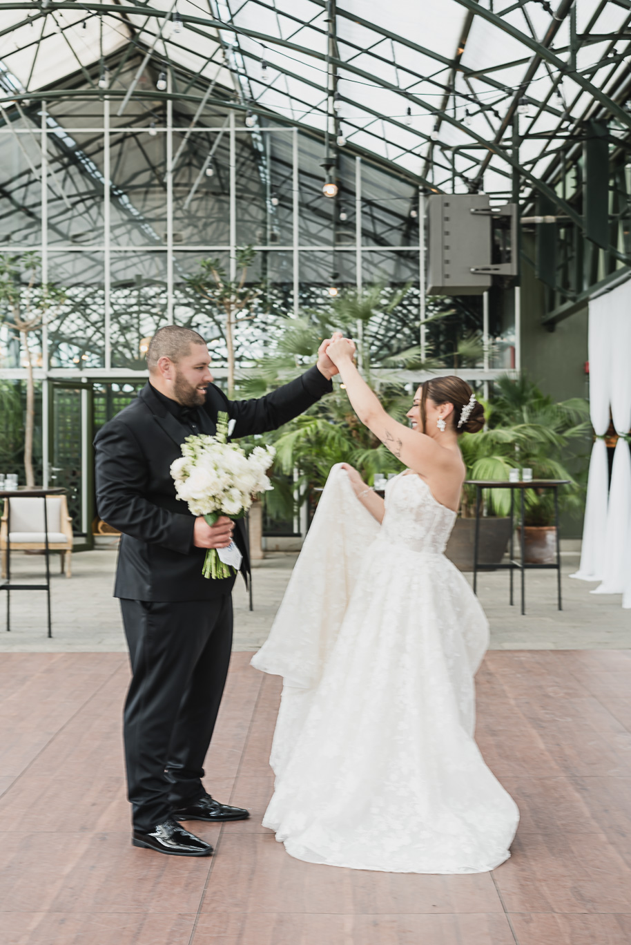 A classic black and white black tie winter Planterra wedding in West Bloomfield, Michigan provided by top-rated Detroit wedding photographer, Kari Dawson and her team.