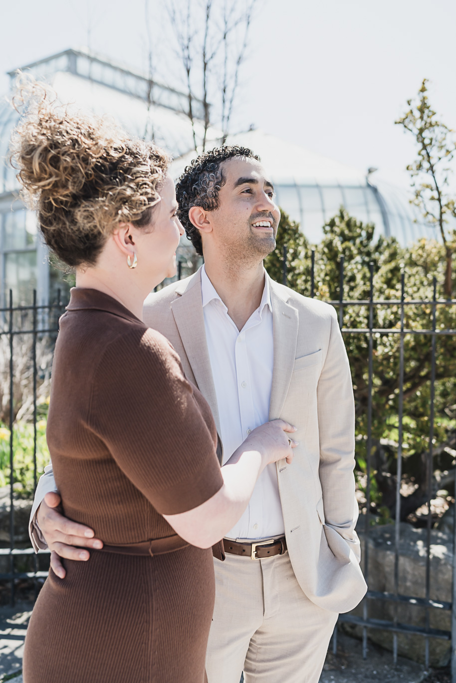 A Bell Isle Engagement Session Detroit waterfront engagement session strolling hand-in-hand beneath soft spring skies.