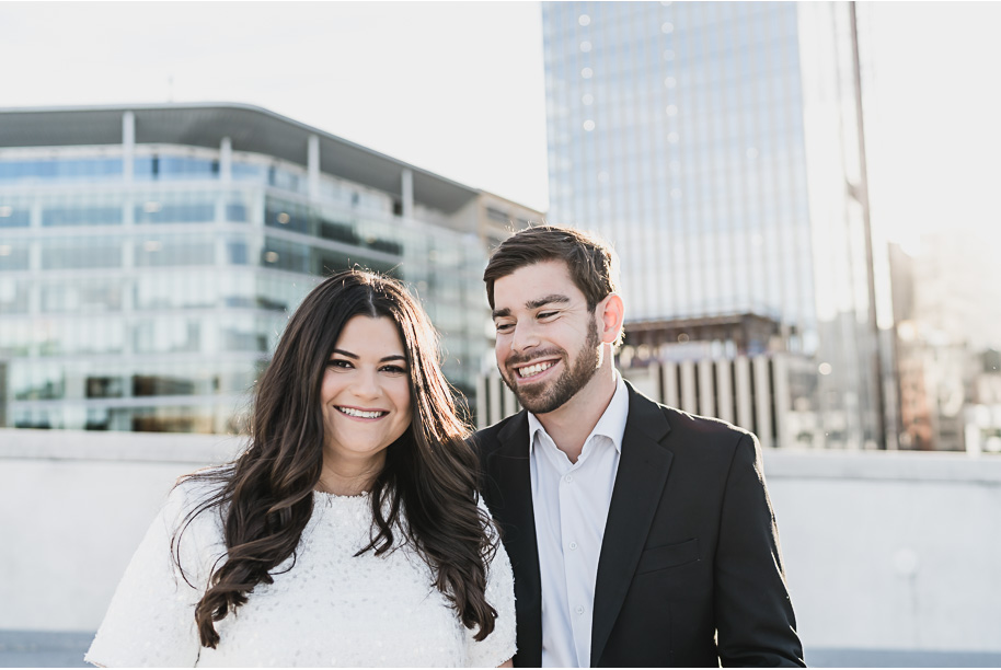 A fun candid moment for this couple during their z lot rooftop downtown Detroit Engagement photos by Kari Dawson