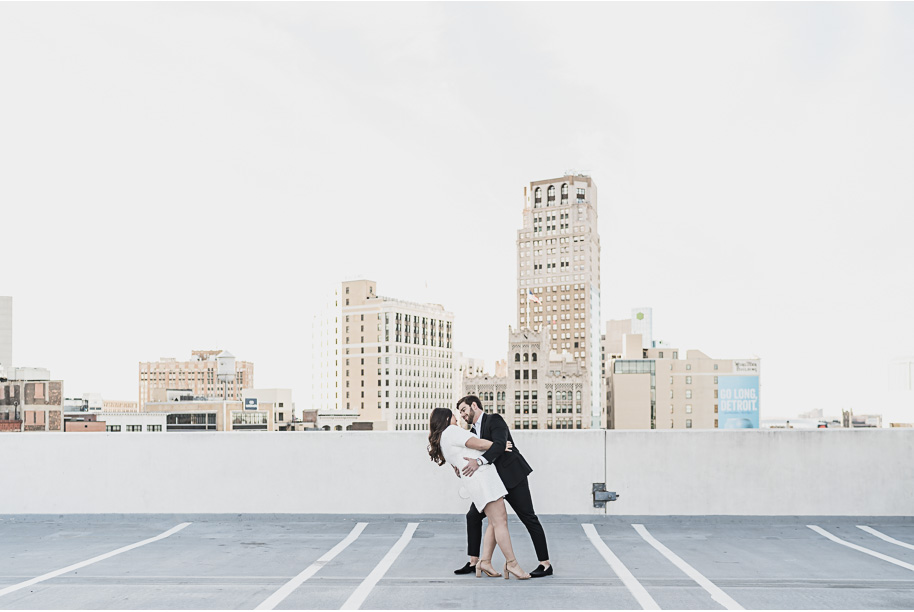Downtown Detroit engagement photos l Rachel and Zach dancing on a rooftop during golden hour